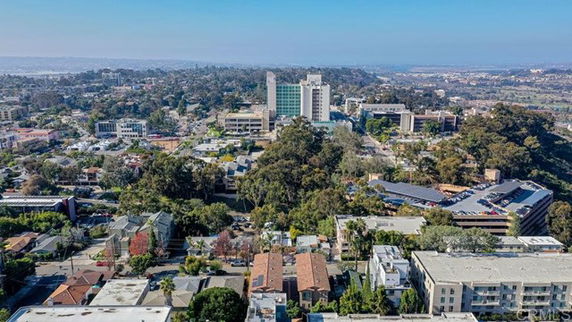 Panoramic view of a cityscape with various buildings and greenery.