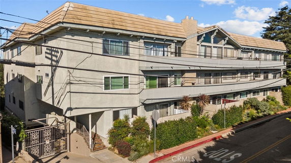 Front view of a multi-story residential building with balconies.