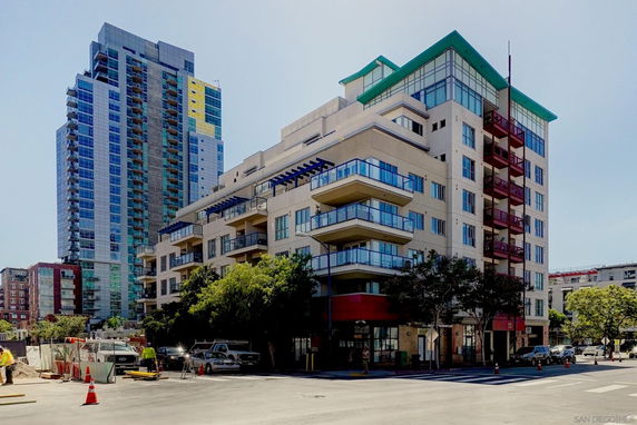 Front view of a multi-story building with modern design and balconies.