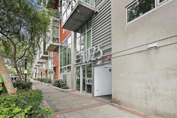 Front view of a modern multi-story building with glass and metal facade.