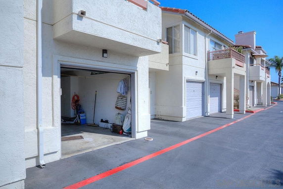 Outdoor view of a residential building with garages.