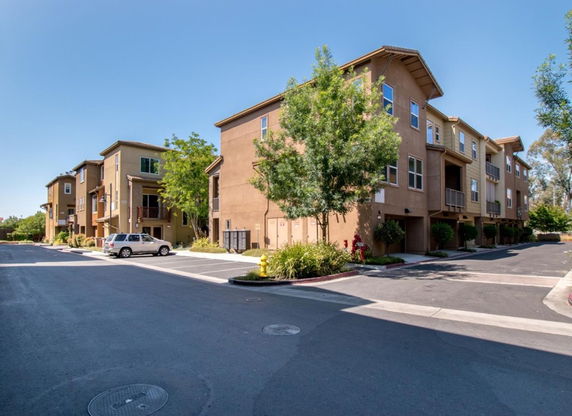Front view of a multi-story apartment building with balconies.