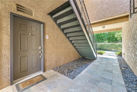 Front view of an entrance under a staircase in a building.