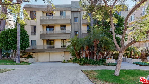 Front view of a multi-story residential building with balconies.