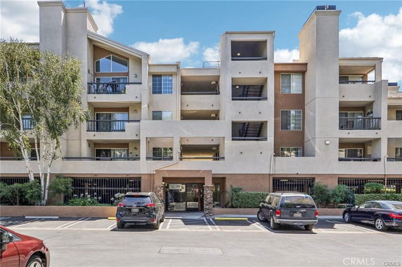 Front view of a multi-story apartment building with balconies