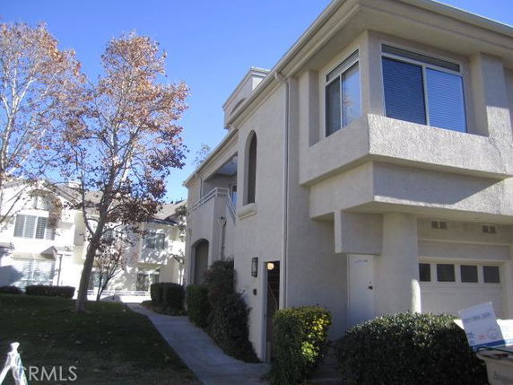 Front view of a two-story house with a modern facade and attached garage.