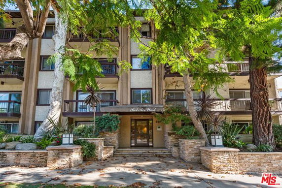Front view of a multi-story residential building with balconies.