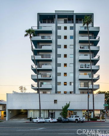 Front view of a multi-story modern building with balconies.