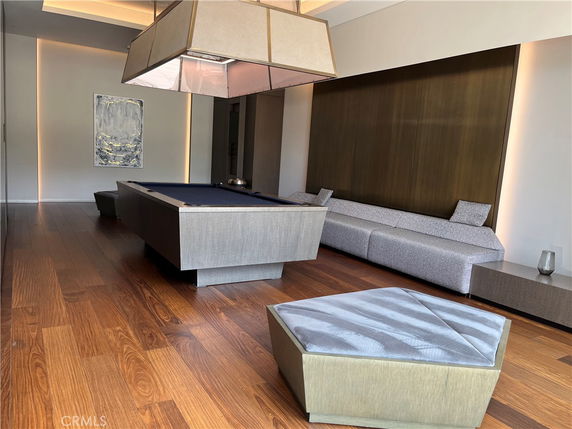 Interior room with a pool table and modern seating.