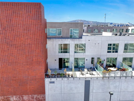 Front view of a modern multi-story building with balconies.
