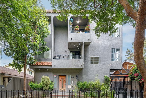 Front view of a multi-story residential building with balconies.