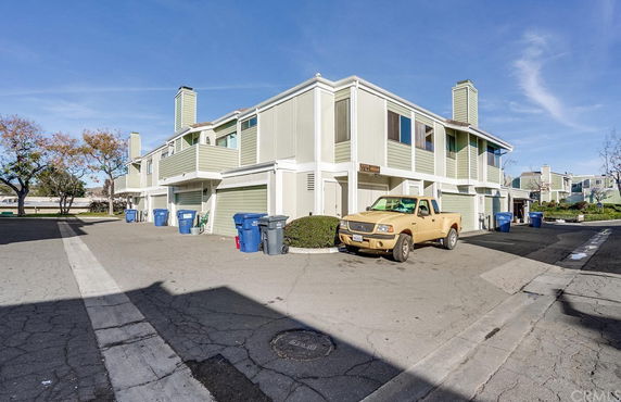 Front view of a two-story residential building with attached garages.