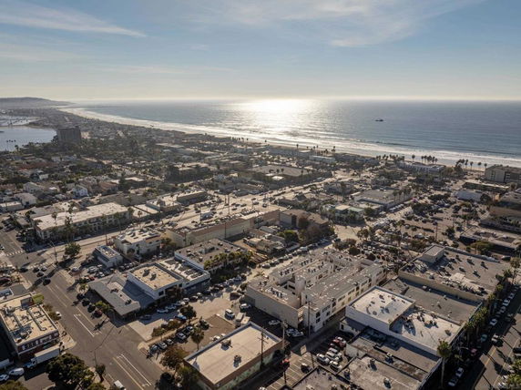 Panoramic view of a coastal city with buildings and ocean.