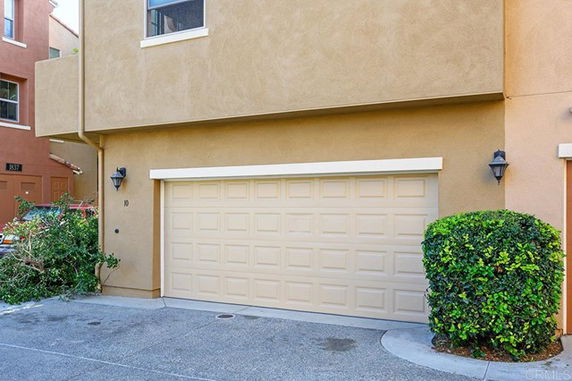 Front view of a house with a beige double garage door.