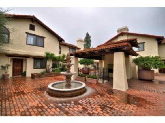 Front view of a residential building with a central fountain.