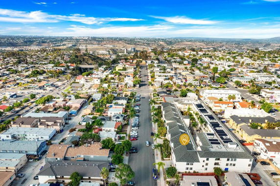 Panoramic aerial view of a residential area with multiple houses and buildings.