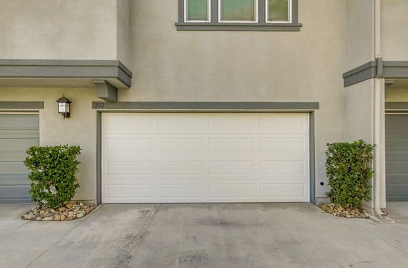 Front view of a house with a garage door.