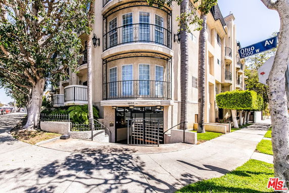 Front view of a multi-story residential building with balconies.