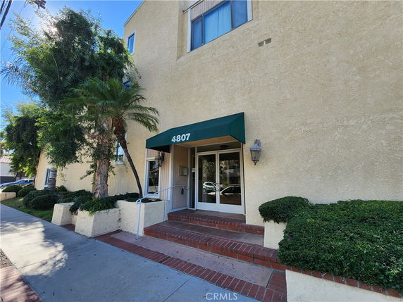 Front view of a building with a green awning over the entrance.