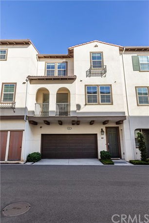Front view of a three-story townhouse with double garage.