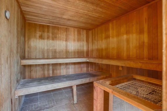 Interior view of a sauna room with wooden benches and walls.