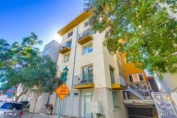 Front view of a multi-story apartment building with balconies.