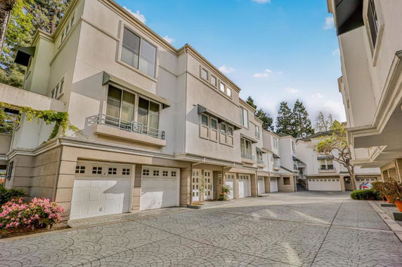 Front view of a multi-story residential building with garages.