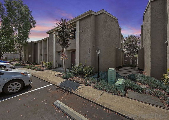 Front view of a two-story building with a flat roof and minimal landscaping.