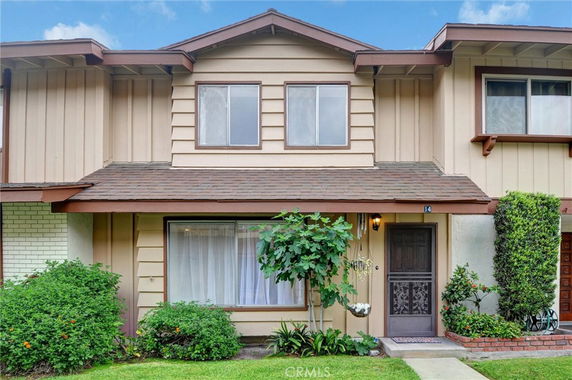 Front view of a two-story townhouse with brown trim and a central entrance.