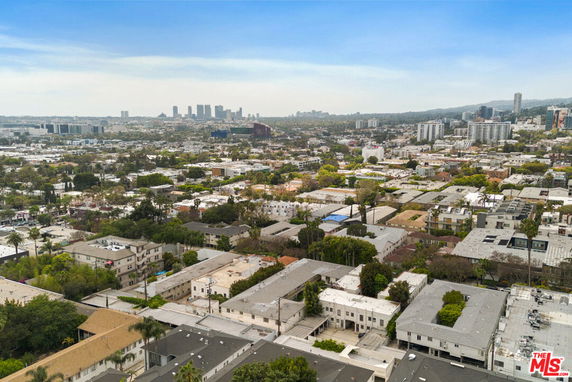 Panoramic view of urban area with buildings and city skyline in the distance.