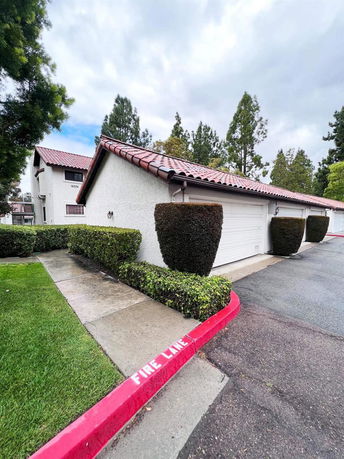 Front view of a house with a two-car garage and red tile roof.