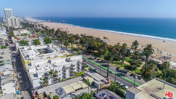 Wide-angle view of beachfront buildings and coastline.