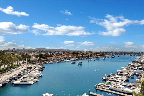Panoramic view of a marina with numerous boats docked alongside piers.