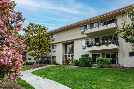 Front view of a multi-story residential building with balconies.
