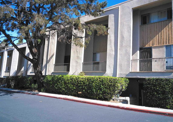 Front view of a multi-story building with balconies.