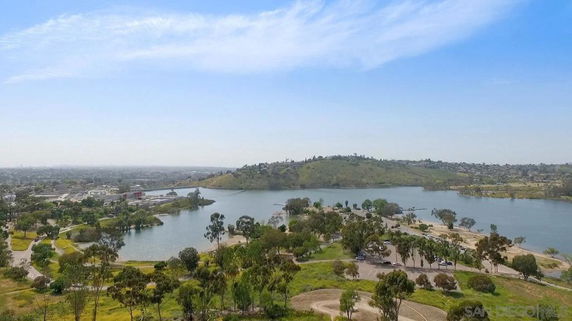 Panoramic view of a landscape with a lake and trees.