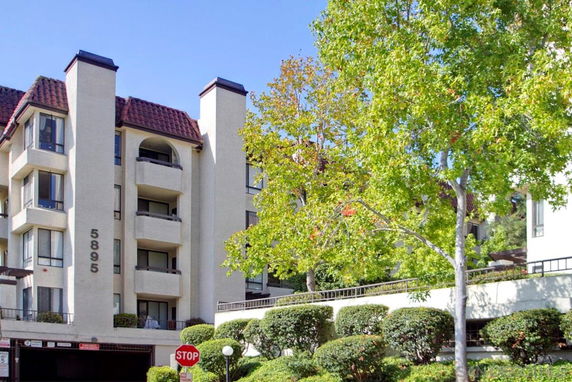 Front view of a multi-story residential building with balconies.