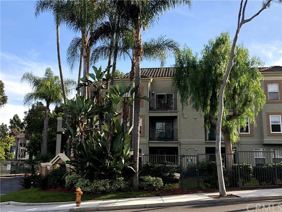 Front view of a multi-story residential building with balconies.