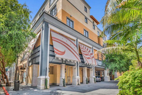 Front view of a multi-story commercial building with decorative awnings.