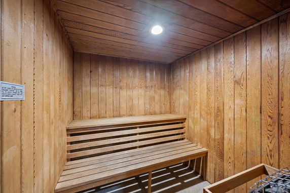 Interior view of a wooden sauna room with benches.