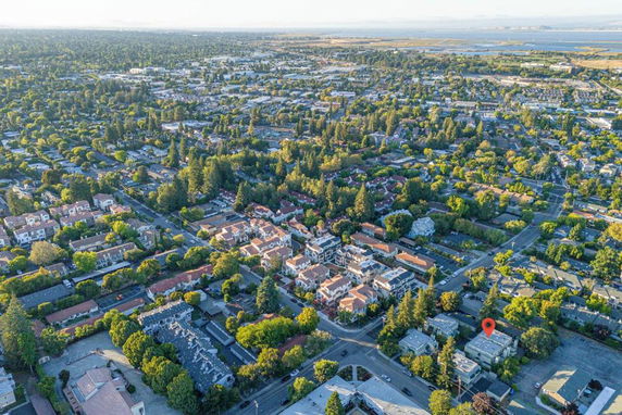 Aerial view of a suburban area with numerous houses and green spaces.