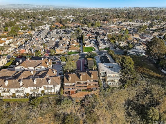 Aerial panoramic view of residential buildings and surrounding area.