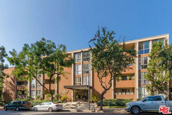 Front view of a multi-story residential building with a central entrance.