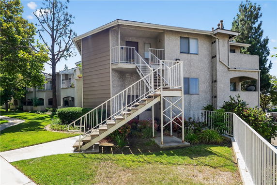 Front view of a two-story building with external staircase.