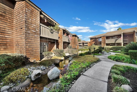 Front view of multi-story residential buildings with wooden exterior.