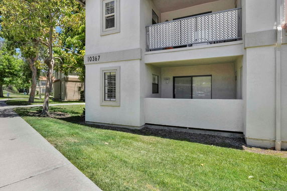 Front view of a multi-story building entrance with a small porch area.