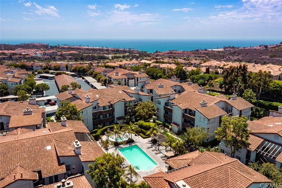 Panoramic view of a residential area with multiple buildings and a swimming pool.