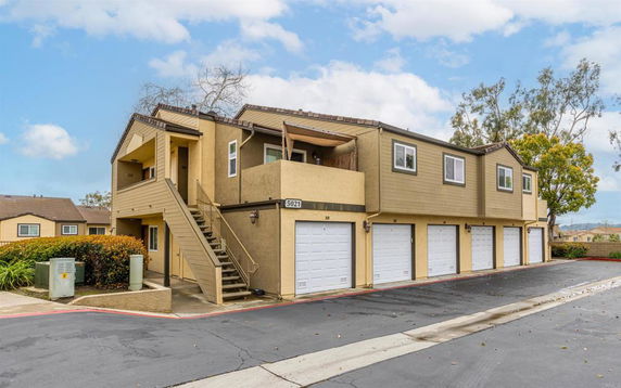 Front view of a two-story building with multiple garage doors.
