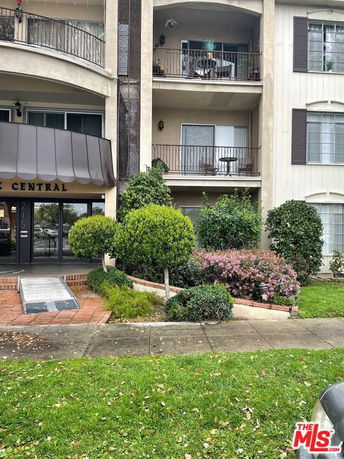 Front view of a multi-story apartment building with balconies.