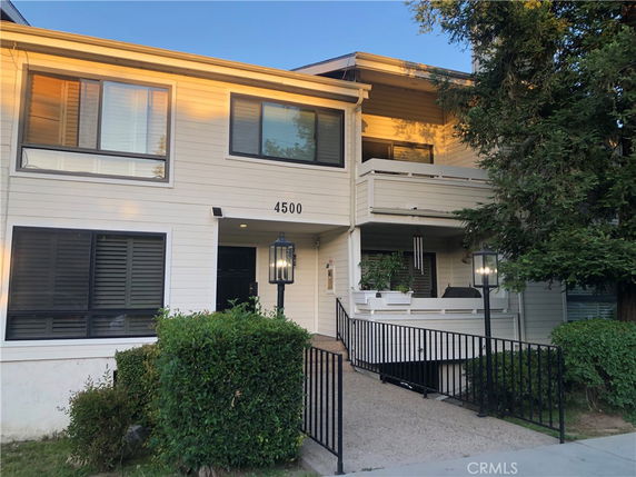 Front view of a two-story residential building with a balcony.